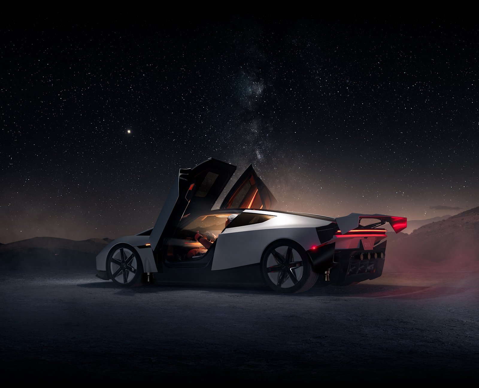 Tesla Roadster with doors open and rear wing raised